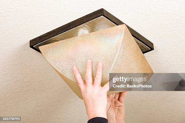 electrician finishing room light installation - installing ceiling light fixture stock pictures, royalty-free photos & images