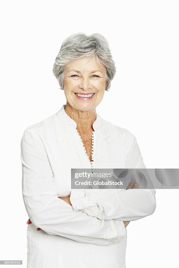 Elderly woman smiling with arms crossed