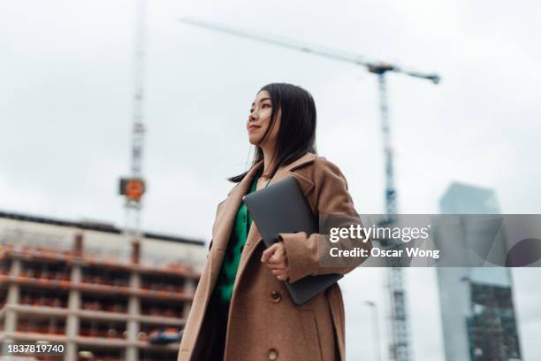 young asian woman working in construction industry - new business construction stock pictures, royalty-free photos & images