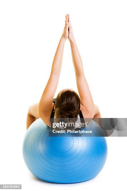 woman holding hands together in the air on a yoga ball - fitness ball stock pictures, royalty-free photos & images