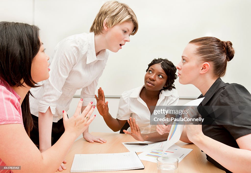 Dispute between two colleagues at a work meeting at desk