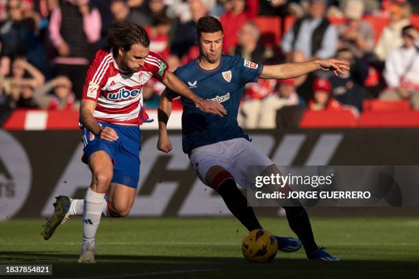 Granada's Spanish defender Ignasi Miquel fights for the ball with Athletic Bilbao's Spanish forward Gorka Guruzeta during the Spanish league football...