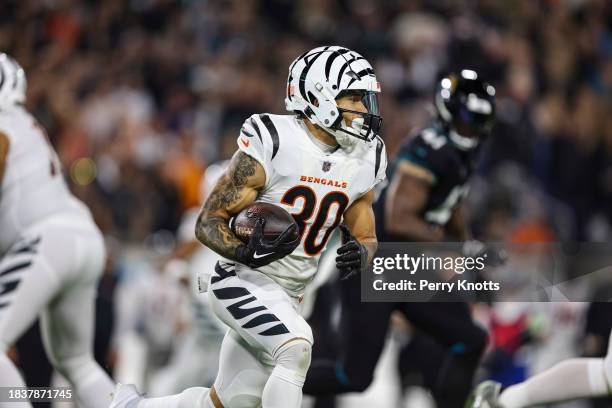 Chase Brown of the Cincinnati Bengals runs the ball during an NFL football game against the Jacksonville Jaguars at EverBank Stadium on December 4,...