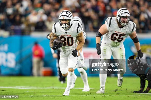 Chase Brown of the Cincinnati Bengals runs the ball during an NFL football game against the Jacksonville Jaguars at EverBank Stadium on December 4,...