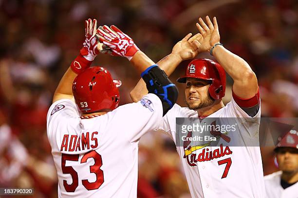 Matt Holliday congratulates Matt Adams of the St. Louis Cardinals on his two-run home run in the eighth inning against the Pittsburgh Pirates during...