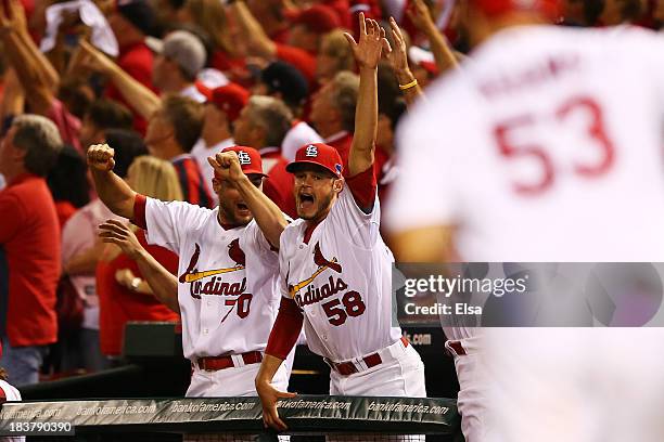 Joe Kelly celebrates as Matt Adams of the St. Louis Cardinals rounds the bases after hitting a two-run home run in the eighth inning against the...