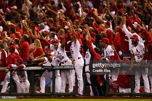 The St. Louis Cardinals celebrate after Matt Adams hit a two-run home run in the eighth inning against the Pittsburgh Pirates during Game Five of the...