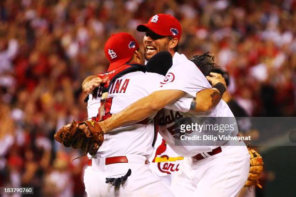 Adam Wainwright celebrates with Yadier Molina of the St. Louis Cardinals after they defeated the Pittsburgh Pirates 6 to 1 in Game Five of the...
