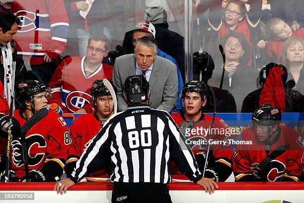 Head coach Bob Hartley of the Calgary Flames has a discussion with a referee during a stoppage in play against the Montreal Canadiens at Scotiabank...