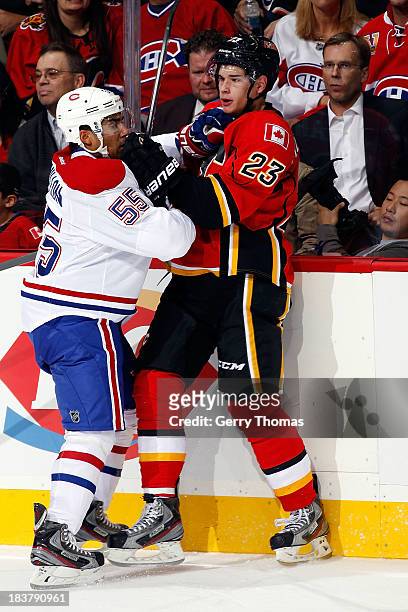 Sean Monahan of the Calgary Flames skates against Francis Bouillon of the Montreal Canadiens at Scotiabank Saddledome on October 9, 2013 in Calgary,...