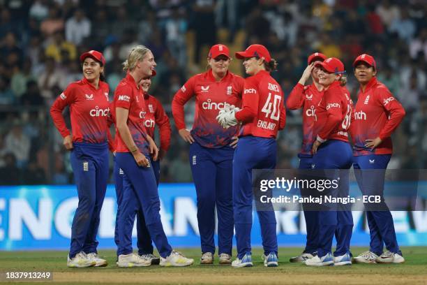 England players wait for a DRS review during the 3rd T20 International match between India Women and England Women at Wankhede Stadium on December...