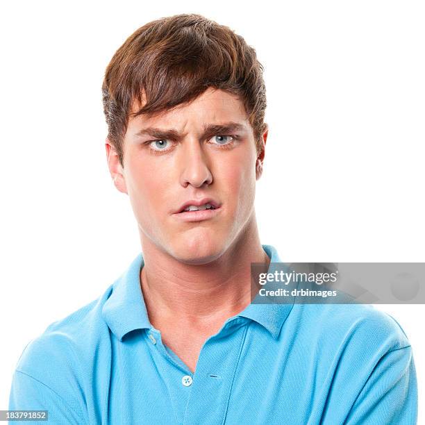 confused young man frowning - face irritation stock pictures, royalty-free photos & images