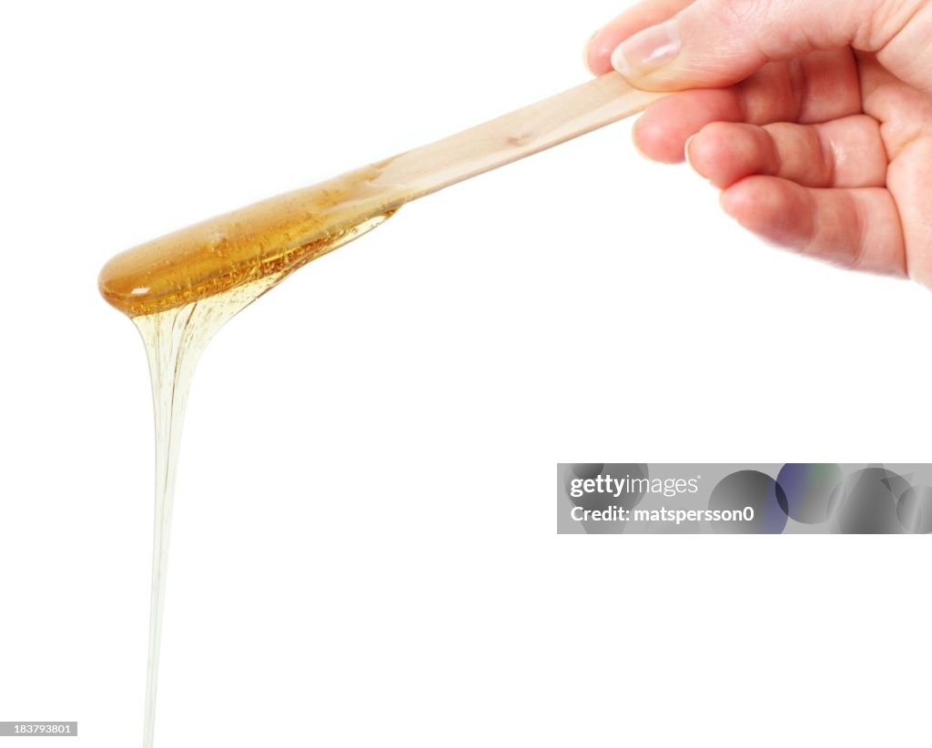 Honey wax on a spatula - Isolated