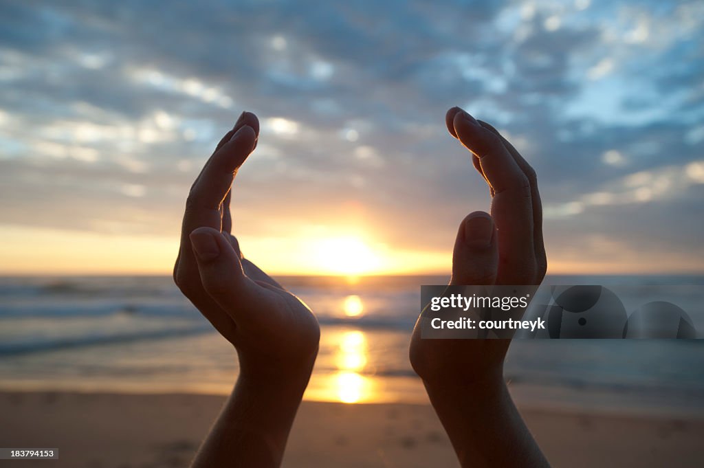 Hands holding the sunrise