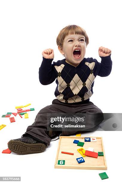 preschooler little boy having emotional stress while playing with toys - furious child stock pictures, royalty-free photos & images