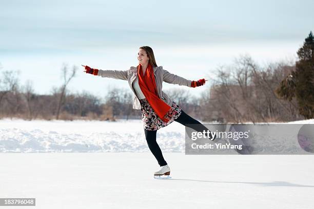 teenage girl figure skating on winter lake ice rink, minneapolis - rode rok stockfoto's en -beelden