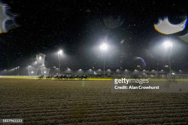 Heavy rain falls on runners in The 2024 Membership Available Now Handicap as they turn into the back straight at Chelmsford City Racecourse on...