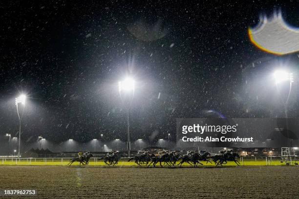 Heavy rain falls on runners in The 2024 Membership Available Now Handicap as they turn into the back straight at Chelmsford City Racecourse on...