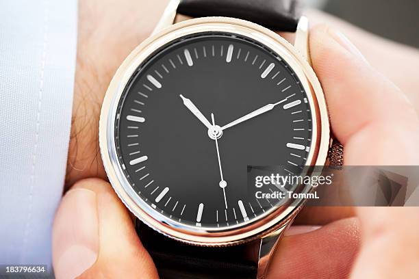 businessman checking time - wrist stock pictures, royalty-free photos & images