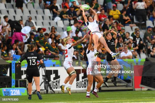 Kayla Canett jumps with the assistance of US' Alex Sedrick to catch a ball during the women's HSBC World Rugby Sevens Series 2023 third place...