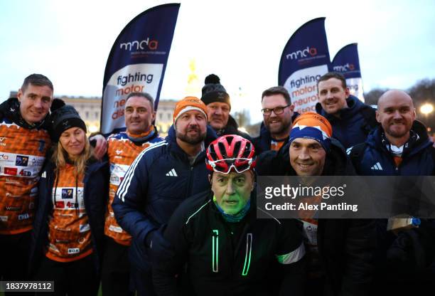 Kevin Sinfield and his team pose for a photo as he Finishes His Ultra 7 In 7 In 7 Marathon Challenge at The Mall In London on December 07, 2023 in...