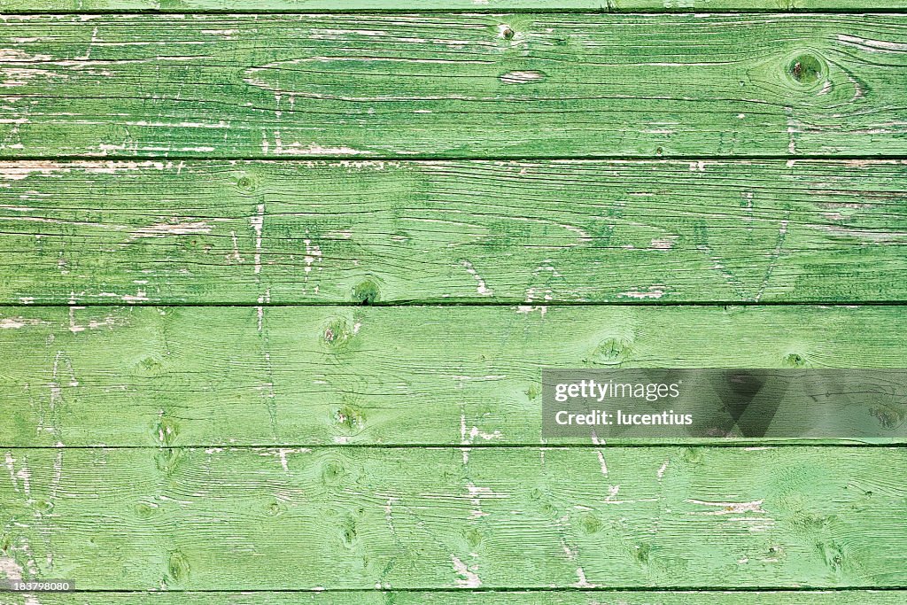 Old wooden panels with uneven green paint