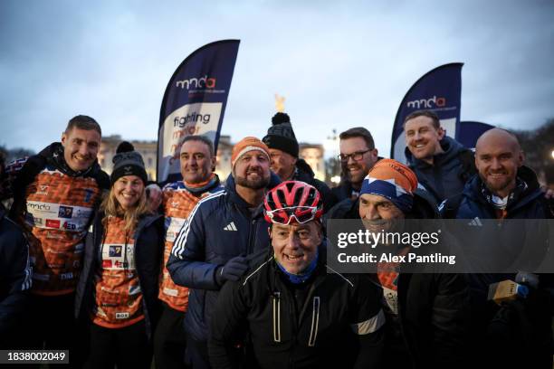 Kevin Sinfield and his team pose for a photo as he Finishes His Ultra 7 In 7 In 7 Marathon Challenge at The Mall In London on December 07, 2023 in...