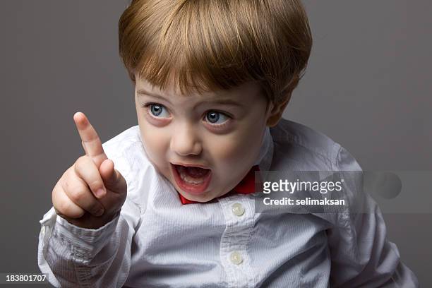 little boy with blonde hair shaking his finger for warning - kid chef stockfoto's en -beelden
