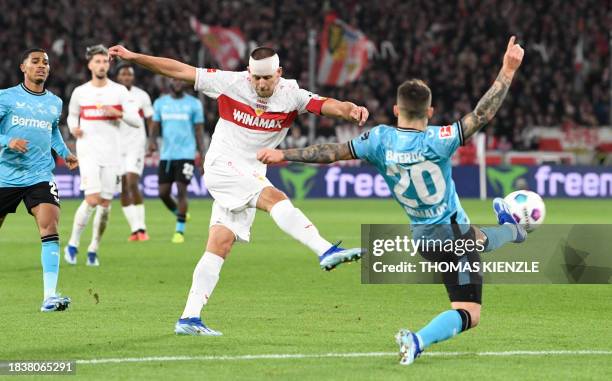 Stuttgart's German defender Waldemar Anton and Bayer Leverkusen's Spanish defender Alejandro Grimaldo vie for the ball during the German first...