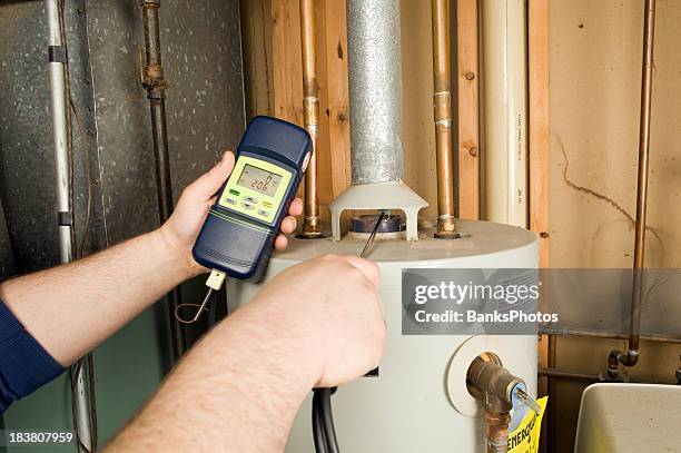 repairman checks carbon monoxide level on gas water heater exhaust - water heater bildbanksfoton och bilder