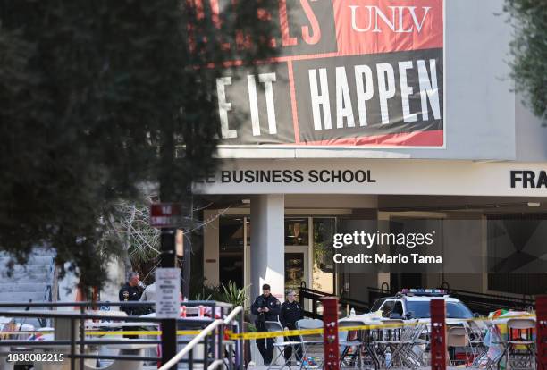 Police officers keep watch near the scene outside Frank and Estella Beam Hall, where the UNLV Lee Business School is located, the morning after a...