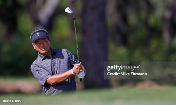 Choi of Korea playing for Team International chips on the fifth hole on day one of the World Champions Cup at The Concession Golf Club on December...