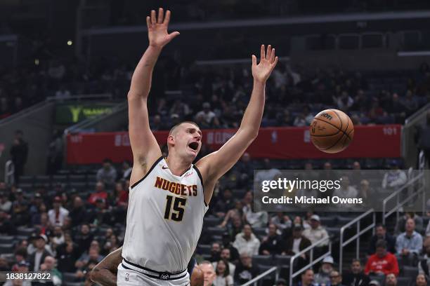 Nikola Jokic of the Denver Nuggets reacts as he's blocked by Paul George of the LA Clippers during a game at Crypto.com Arena on December 06, 2023 in...