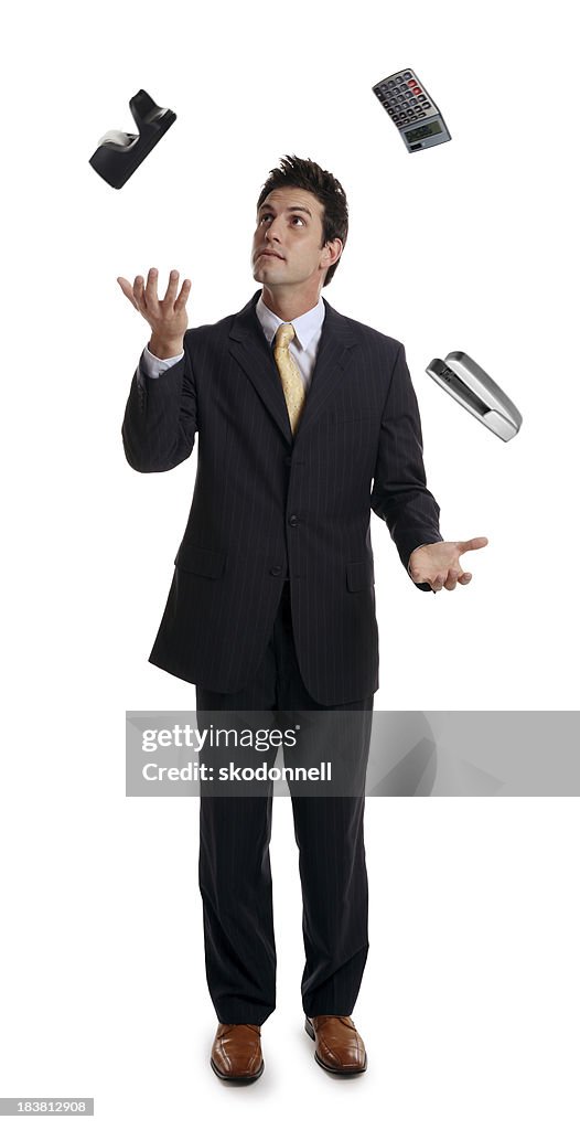 Businessman Juggling Office Supplies