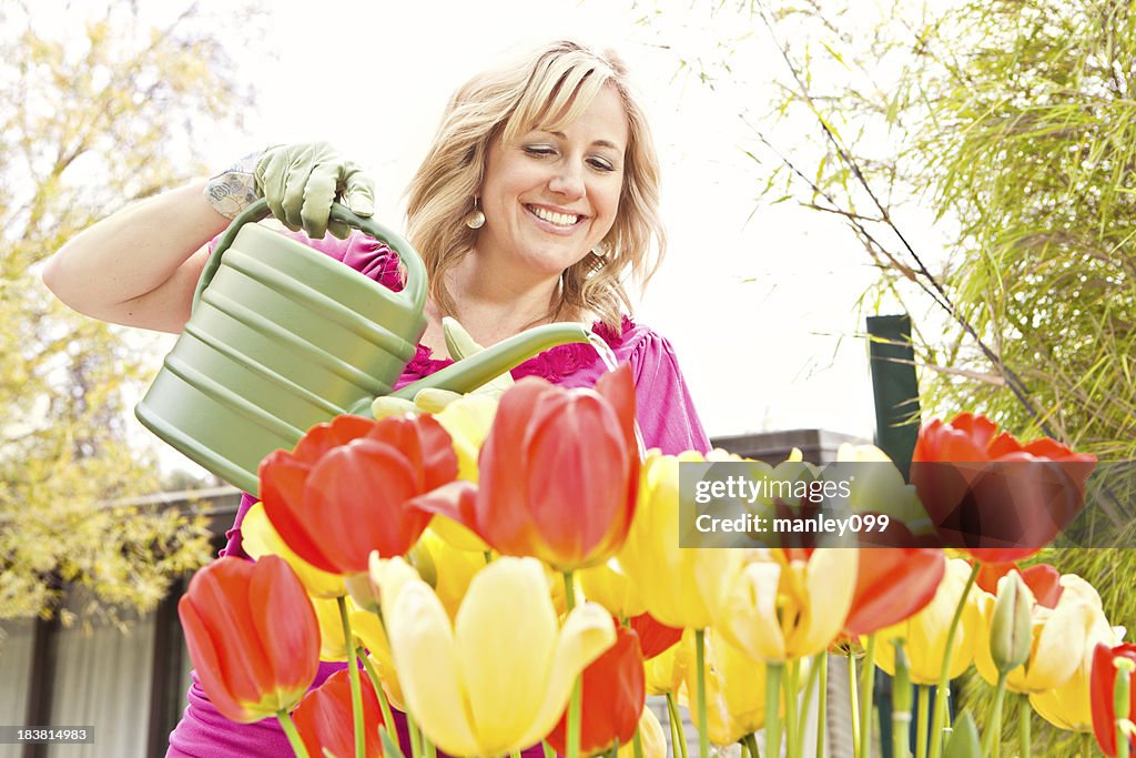 Lady watering beautiful flowers