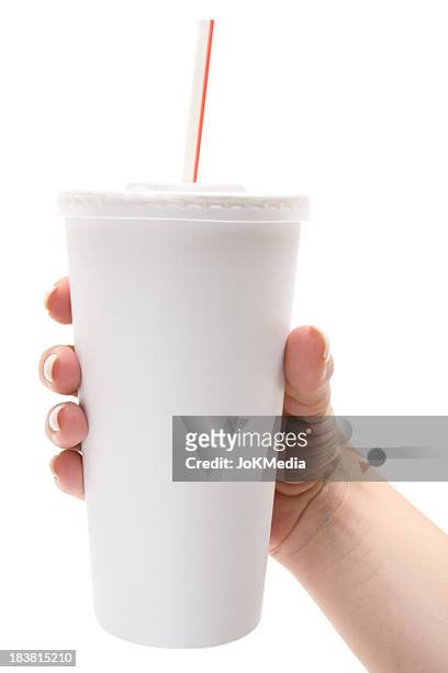 female hand holds white disposable cup - rietje stockfoto's en -beelden