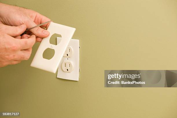 electrician installing electric outlet insulation pad - plug socket stock pictures, royalty-free photos & images