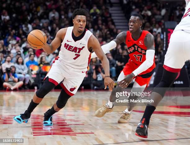Kyle Lowry of the Miami Heat dribbles against Dennis Schroder of the Toronto Raptors during the first half of their basketball game at the Scotiabank...