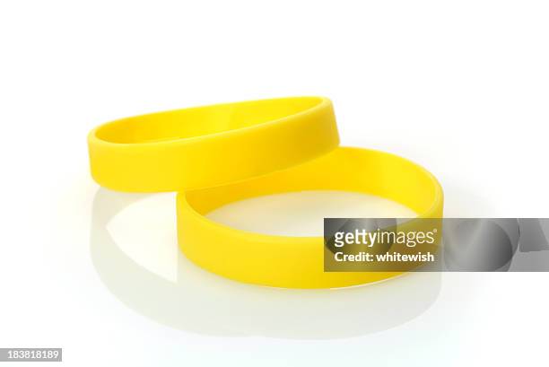 yellow wristband - rubber stock pictures, royalty-free photos & images