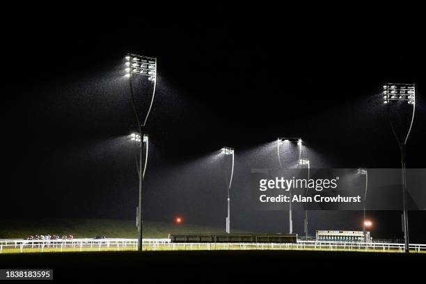 General view as runners race down the back straight during The Racing Welfare Handicap in heavy rain at Chelmsford City Racecourse on December 07,...