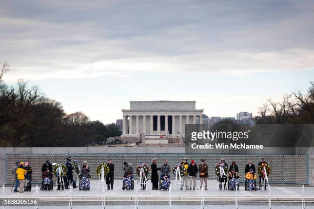 World War II veterans of the U.S. Military participate in a wreath laying ceremony at the National World War II Memorial December 7, 2023 in...