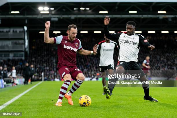 Vladimír Coufal of West Ham is challenged by Fodé Ballo-Touré of Fulham during the Premier League match between Fulham FC and West Ham United at...