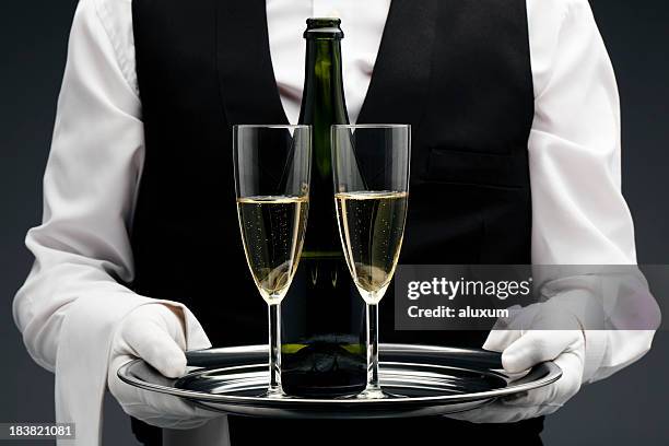 champagne being served by a waiter - butler stock pictures, royalty-free photos & images