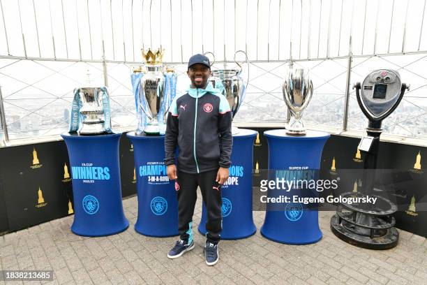 Shaun-Wright Phillips visits the Empire State Building with Manchester City F.C. Treble Trophies at The Empire State Building on December 07, 2023 in...