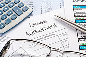 Lease Agreement Form with pen, calculator
