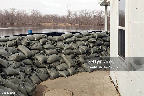 sandbag wall prepared for a major river flood - flood preparation stock pictures, royalty-free photos & images