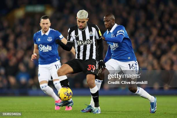 Bruno Guimaraes of Newcastle United is challenged by Abdoulaye Doucoure of Everton during the Premier League match between Everton FC and Newcastle...