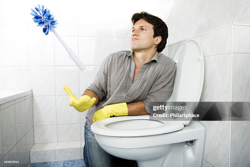 Cleaning young man in bathroom