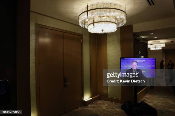 Television screen displays British Foreign Secretary David Cameron speaking at the Aspen Security Forum on December 07, 2023 in Washington, DC....