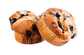 Three blueberry muffins on white background